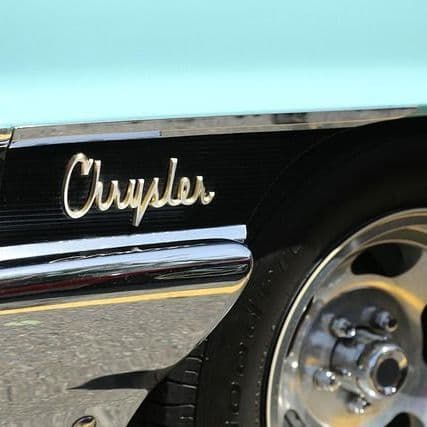 Crews begin installing neon lettering on Chrysler-Plymouth Tower in Bristow